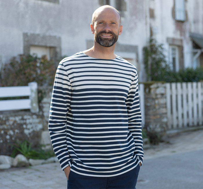 Man wearing a green and beige breton stripe t-shirt