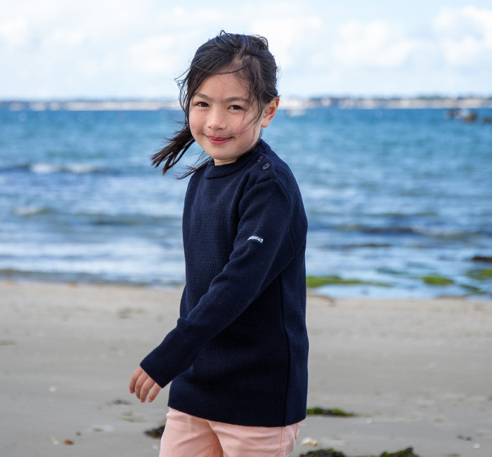 Child wearing a navy blue sailor sweater