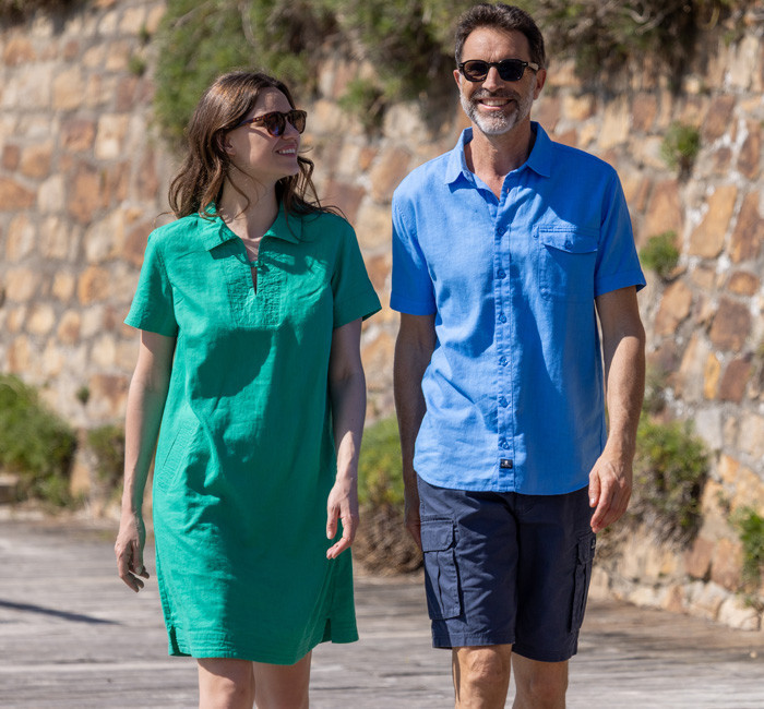 Man wearing a white ramie shirt and woman wearing a pink ramie dress with fish print