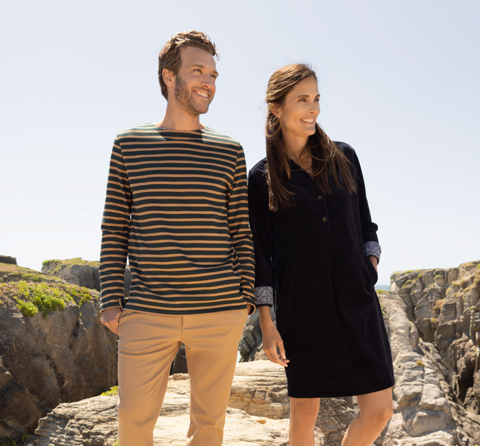 Man wearing a breton stripe t-shirt and woman wearing a corduroy dress